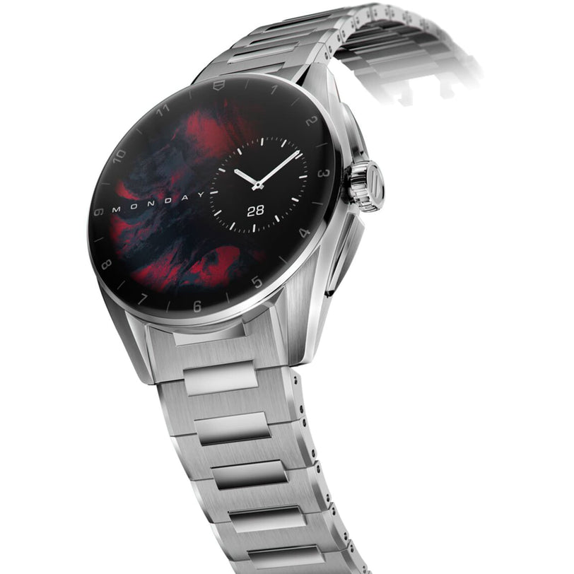 The TAG Heuer Connected Calibre E4 is a silver metal smartwatch with a black and red abstract dial, displaying Monday and the 28th, blending cutting-edge tech with true luxury.