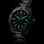 The TAG Heuer Aquaracer Professional 200 sports watch features a black metal band, glowing green hour markers and hands, and a stainless steel case, displayed against a black background.
