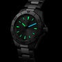 A TAG Heuer Aquaracer Professional 200 watch in stainless steel, featuring luminous green and blue markers on the dial and hands, is displayed against a black background.