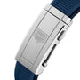 Close-up of a silver metal clasp with an engraved shield logo on the TAG Heuer Aquaracer Professional 300 GMT, attached to a blue textured rubber strap.