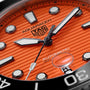 Close-up of the TAG Heuer Aquaracer Professional 300 Orange Diver, featuring an orange dial with bold markers and hands in a 43mm stainless steel case, displaying Automatic 300m/1000ft.
