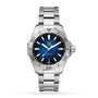 The TAG Heuer Aquaracer Professional 200 Date is a silver diving watch with a blue dial, silver markers, date at 6 o’clock, and a stainless steel case and bracelet, shown against a white background.