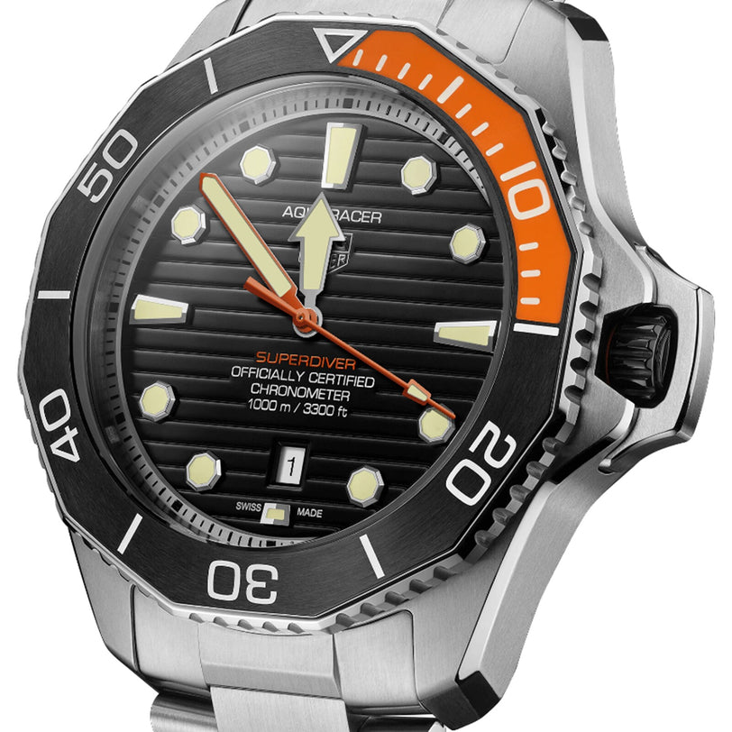 Close-up of a TAG Heuer Aquaracer Professional 1000 Superdiver watch with black and orange bezel, black dial, stainless steel case and bracelet, water resistance, and date display at 6 o’clock.