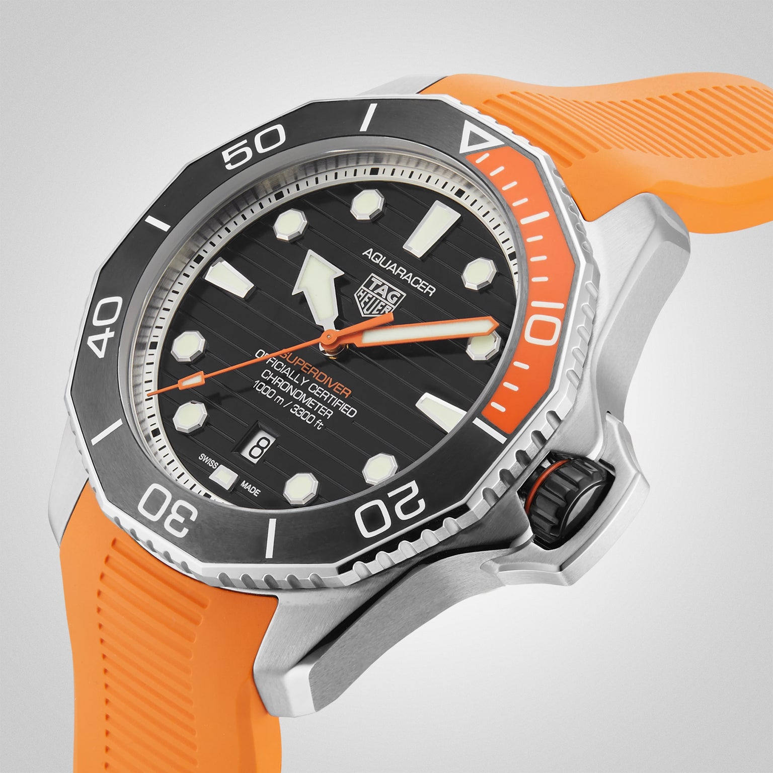 The TAG Heuer Aquaracer Professional 1000 Superdiver features a silver case, water resistance, black dial with white markers, and an orange rubber strap, displayed against a plain light background.