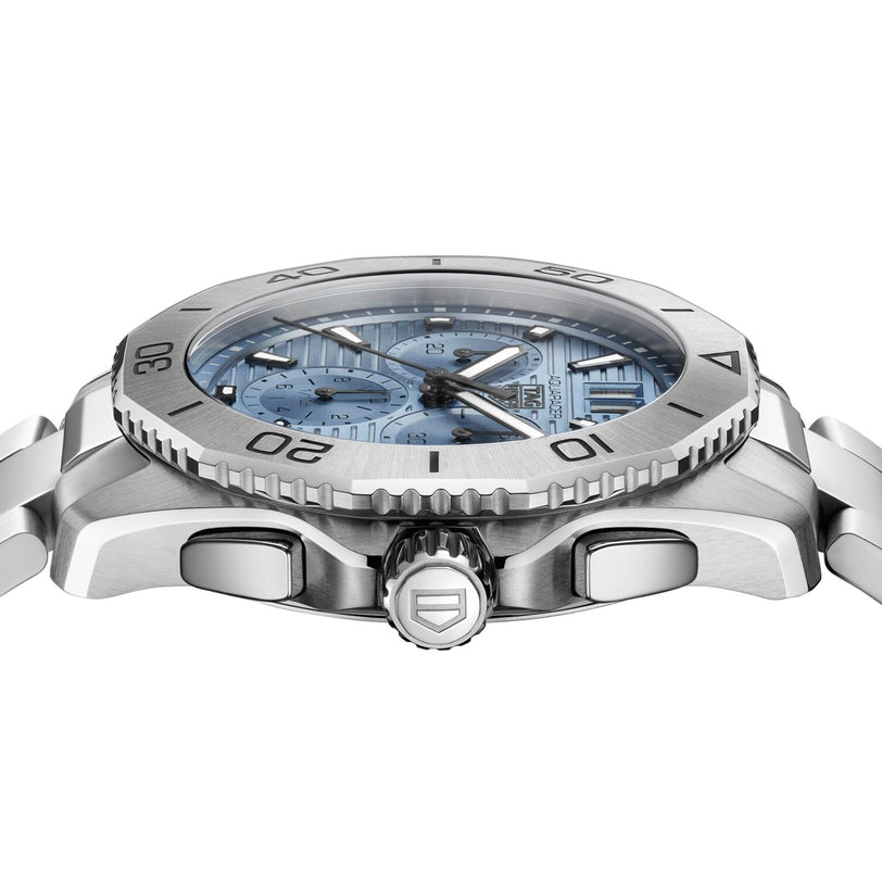 Side view of the TAG Heuer Aquaracer Professional 200 Chronograph in silver stainless steel, featuring a light blue textured dial, rotating bezel, and shield-logo crown—a standout in sports watch design.