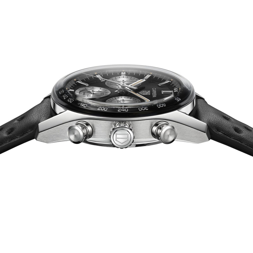 A close-up side view of the TAG Heuer Carrera Chronograph, featuring an analog display, black leather strap, silver accents, two side push buttons, and automatic movement.