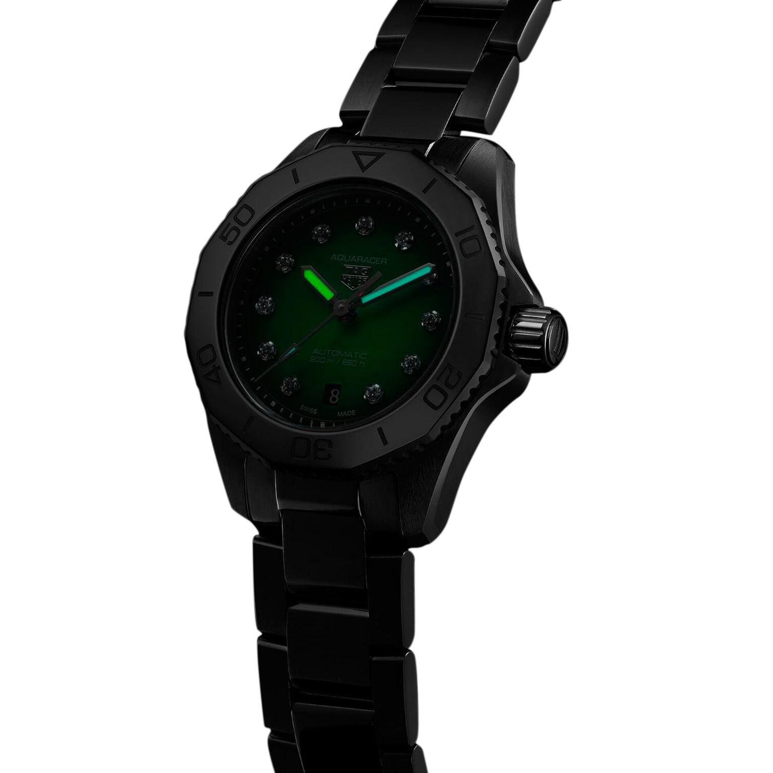 The TAG Heuer Aquaracer Professional 200, a black metal sports watch with a green face, luminous hands, and diamond hour markers, is displayed at an angle on a plain white background.