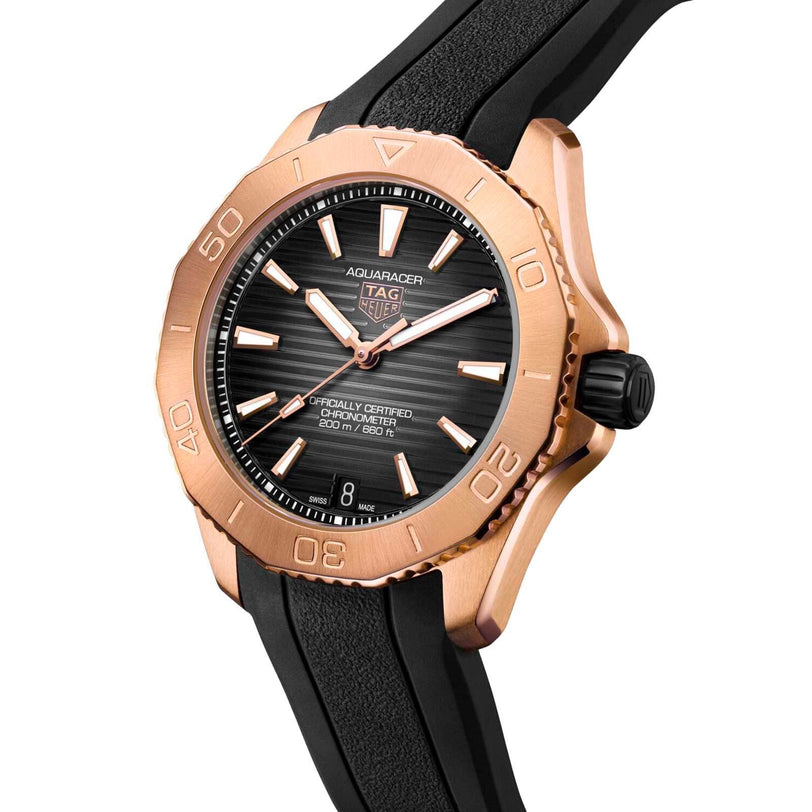 The TAG Heuer Aquaracer Professional 200 watch, featuring a black dial, rose gold-tone bezel, and black rubber strap, is shown angled to showcase its face and side profile, powered by the precise TH31-00 calibre movement.