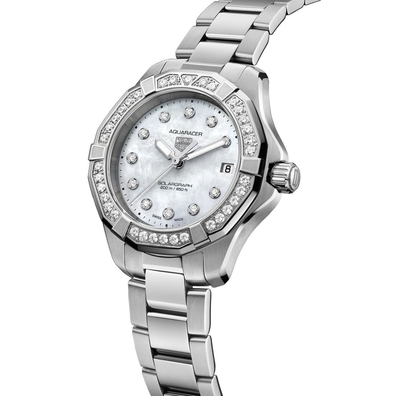 The TAG Heuer Aquaracer 200 Professional Solargraph is a silver watch with a diamond-set bezel, mother-of-pearl dial, date window, and stainless steel bracelet, featuring advanced solar power for reliable performance.