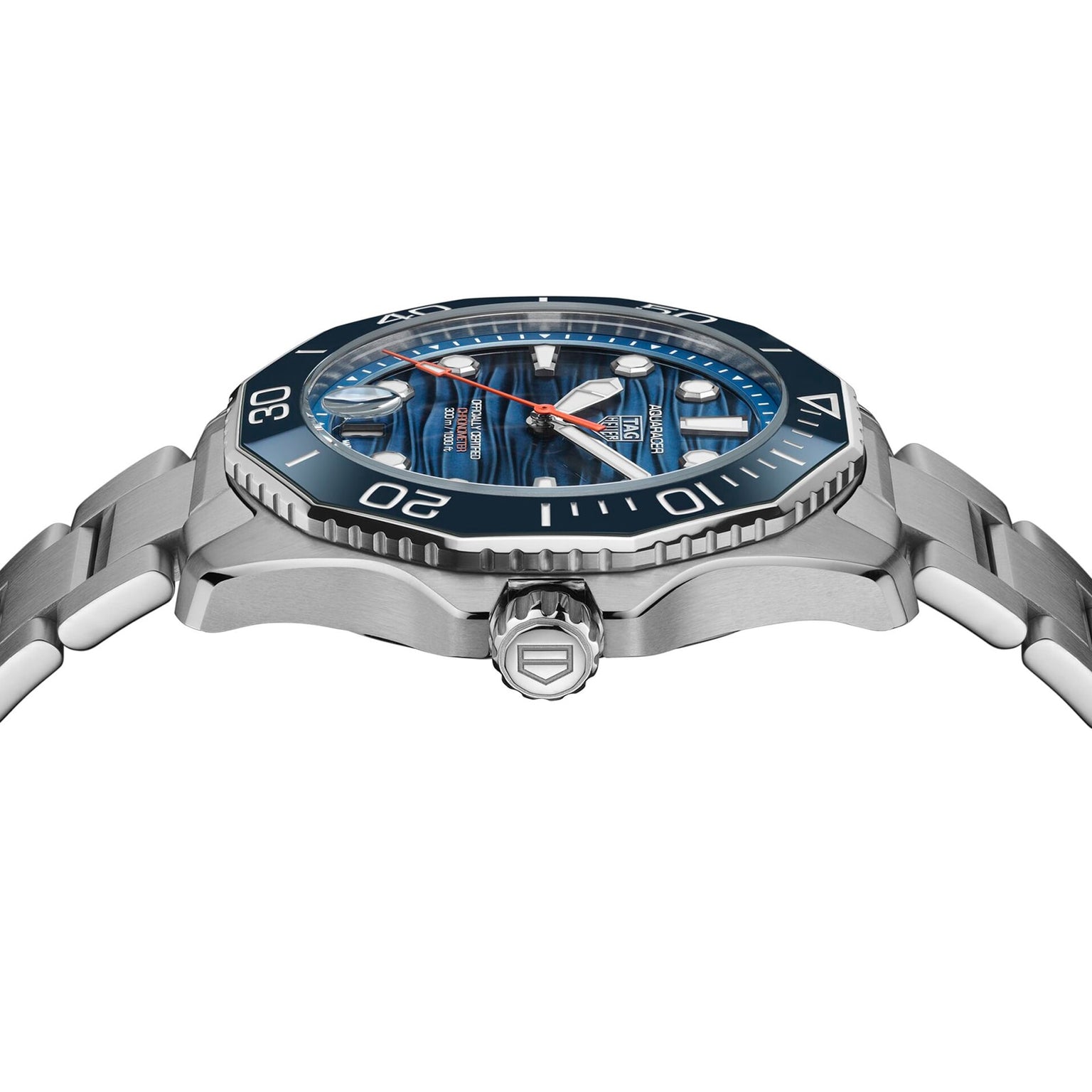 A close-up side view of the TAG Heuer Aquaracer Professional 300 Date, a Swiss-made watch with a stainless steel case, blue bezel and dial, silver markers, and a metal bracelet.