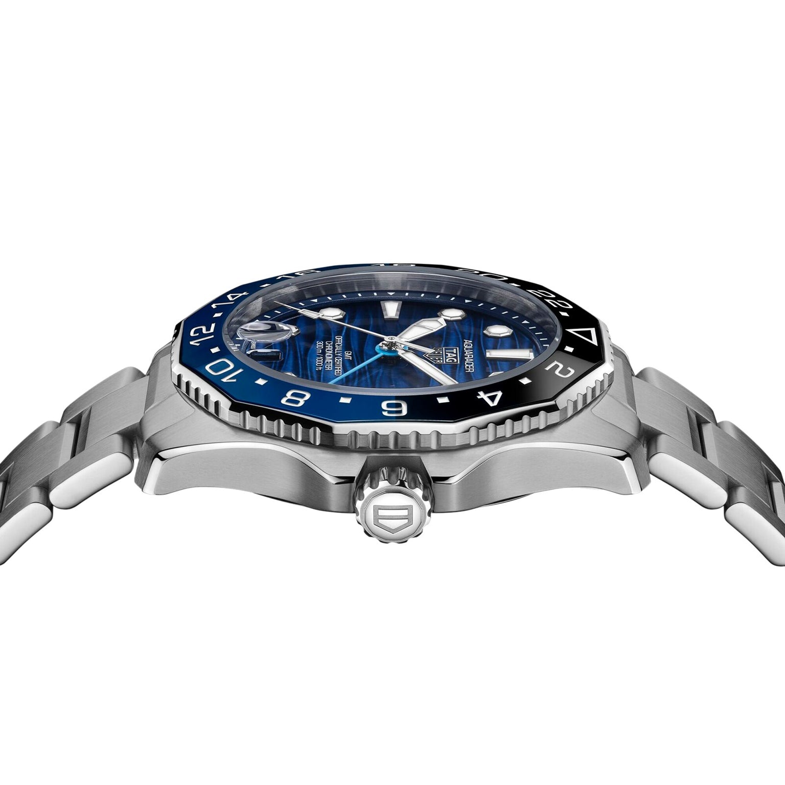 A close-up side view of the TAG Heuer Aquaracer Professional 300 GMT, a luxury stainless steel watch featuring a blue and black bezel, blue dial, and silver bracelet.