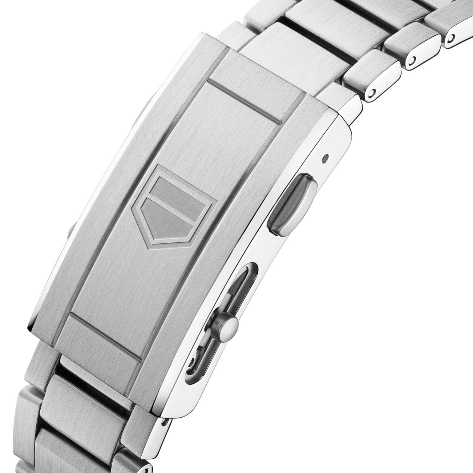 Close-up of a stainless steel TAG Heuer clasp with engraved shield logo and deployment button, as featured on the Aquaracer Professional 300 GMT luxury watch.