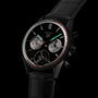 The TAG Heuer Carrera Tourbillon Centenary The Watches of Switzerland Group Exclusive features a black dial, silver subdials, red accents, visible tourbillon, and a leather strap.