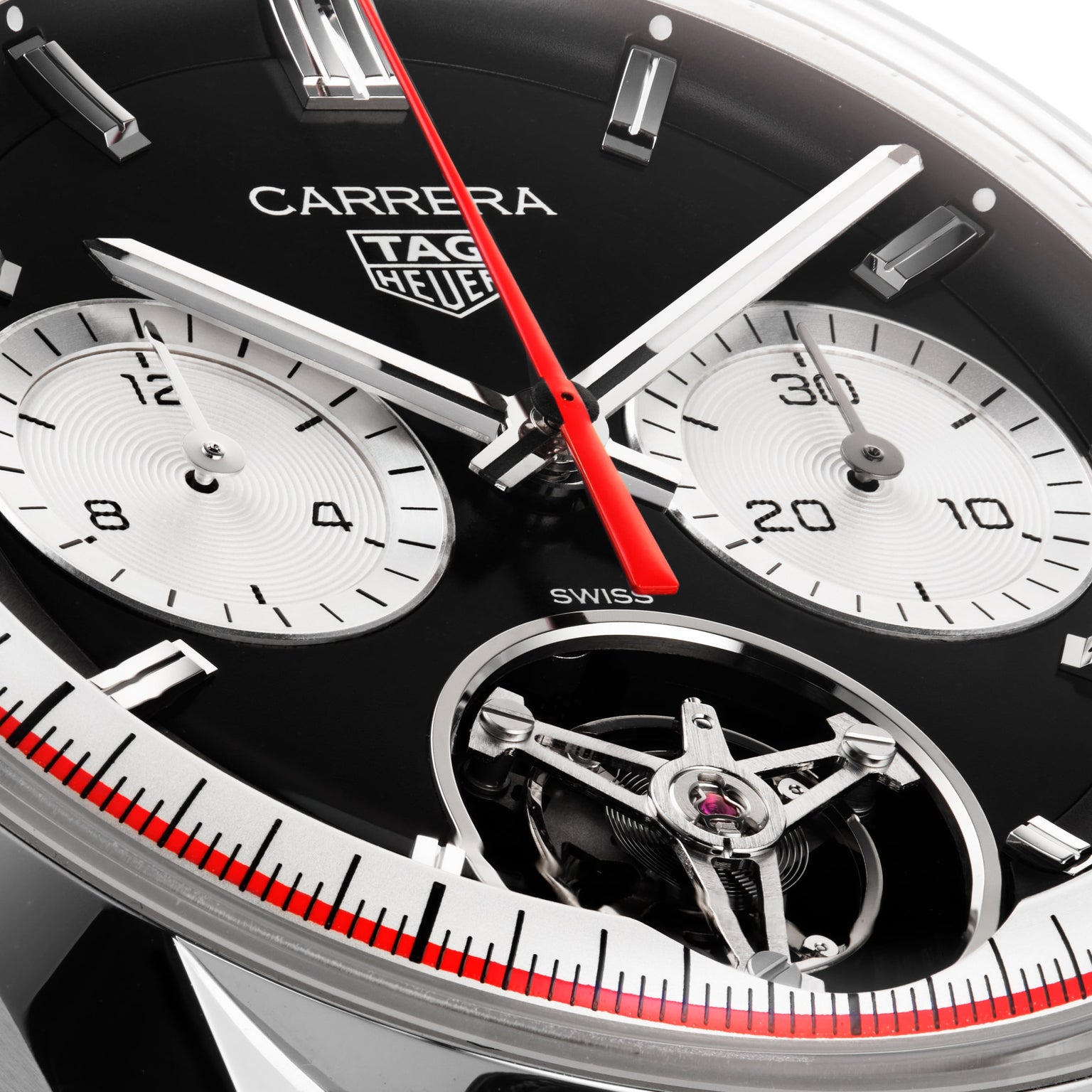 Close-up of the TAG Heuer Carrera Tourbillon Centenary The Watches of Switzerland Group Exclusive, showcasing the brand logo, chronograph dials, red seconds hand, and exposed tourbillon mechanism.