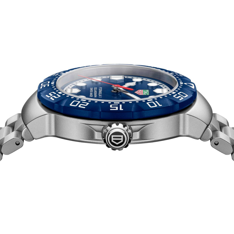 Side view of a TAG Heuer Formula 1 Solargraph wristwatch featuring a silver and blue design, metal band, and detailed bezel.