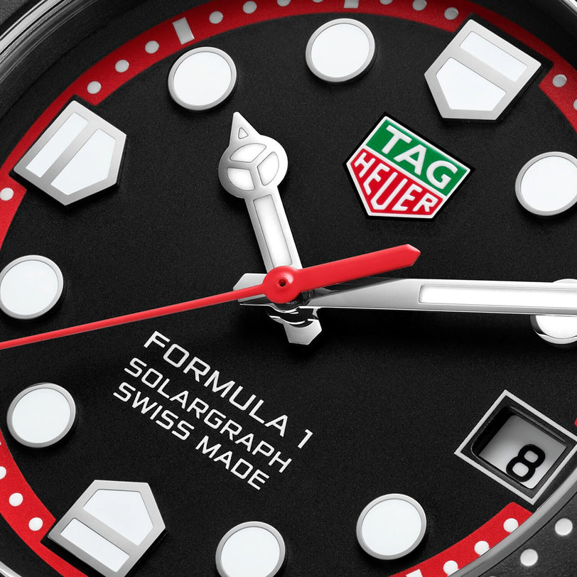 Close-up of a TAG Heuer Formula 1 Solargraph watch face, featuring hands, logo, date window, and intricate hour markers.
