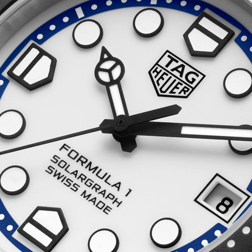 Close-up of a TAG Heuer Formula 1 Solargraph watch face displaying the hands, TAG Heuer logo, date window, and Swiss Made label.