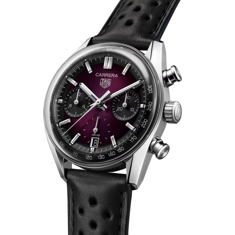 The TAG Heuer Carrera Chronograph features a smokey purple sunray dial, three subdials, date display, and black perforated leather strap—an automatic watch combining sporty sophistication and elegance.
