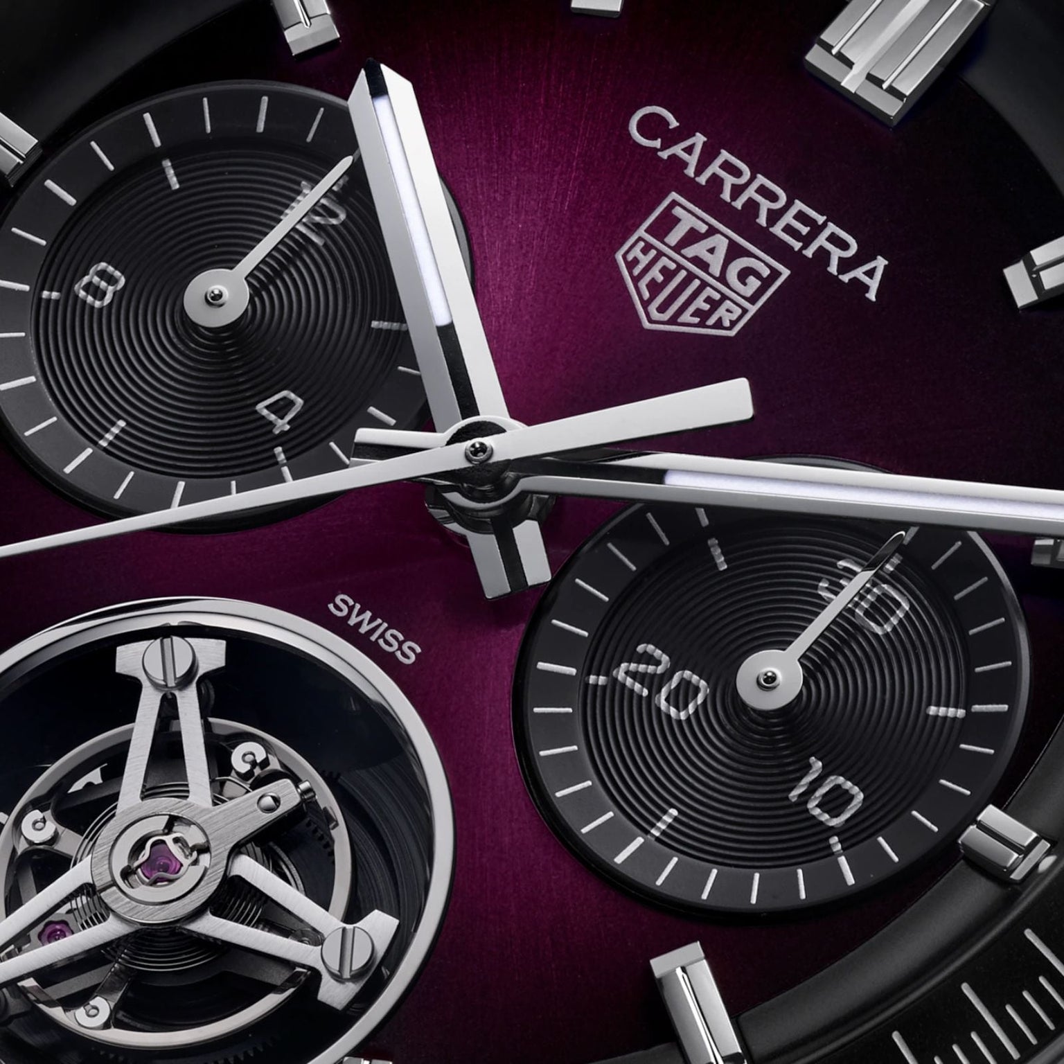 Close-up of a TAG Heuer Carrera Chronograph Tourbillon Limited Edition watch face with a purple background, showing its subdials and hands.