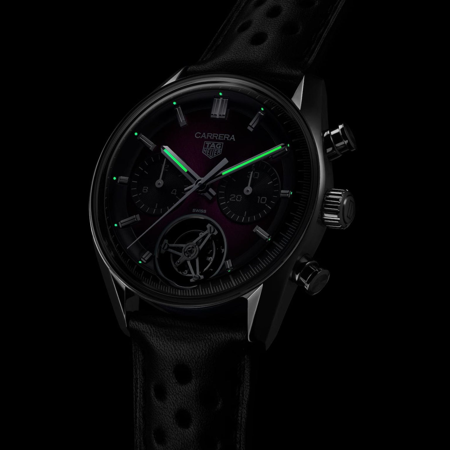 The TAG Heuer Carrera Chronograph Tourbillon Limited Edition features glowing green hour and minute hands, a black chronograph dial, and a sleek black strap.