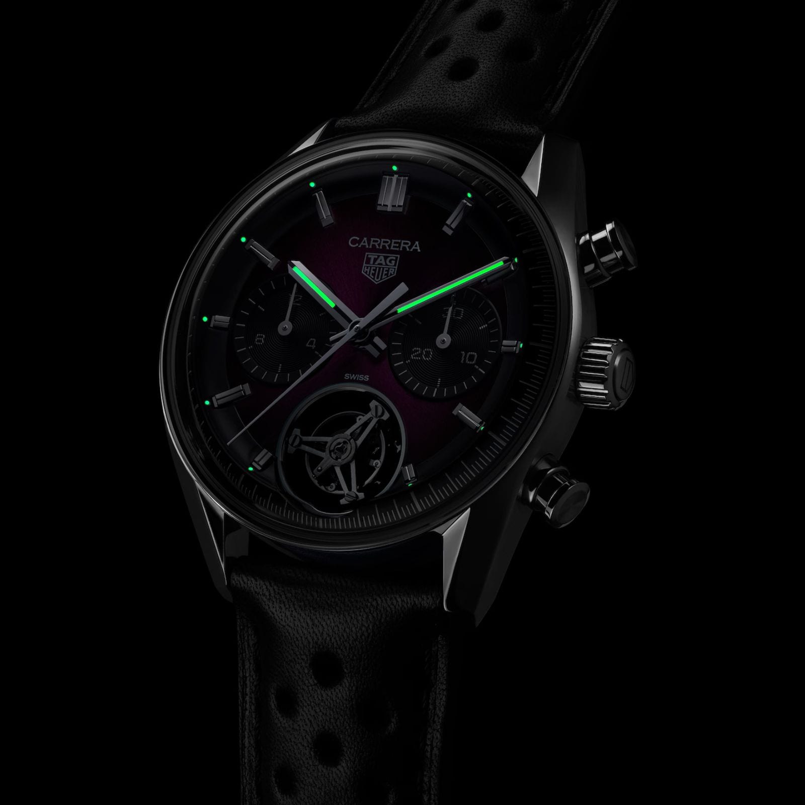 The TAG Heuer Carrera Chronograph Tourbillon Limited Edition features glowing green hour and minute hands, a black chronograph dial, and a sleek black strap.