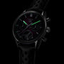 The TAG Heuer Carrera Chronograph Tourbillon Limited Edition features glowing green hour and minute hands, a black chronograph dial, and a sleek black strap.