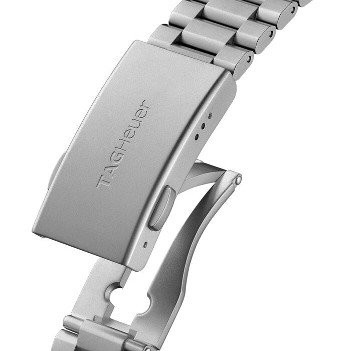 Close-up of a silver watch band with 'TAG Heuer' engraving on a white background