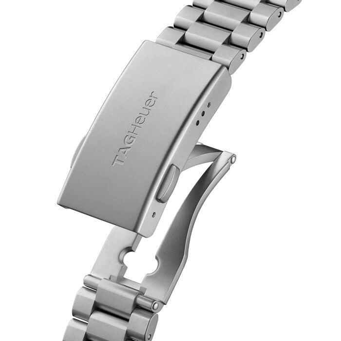 Close-up of a silver watch band with 'TAG Heuer' branding on a white background