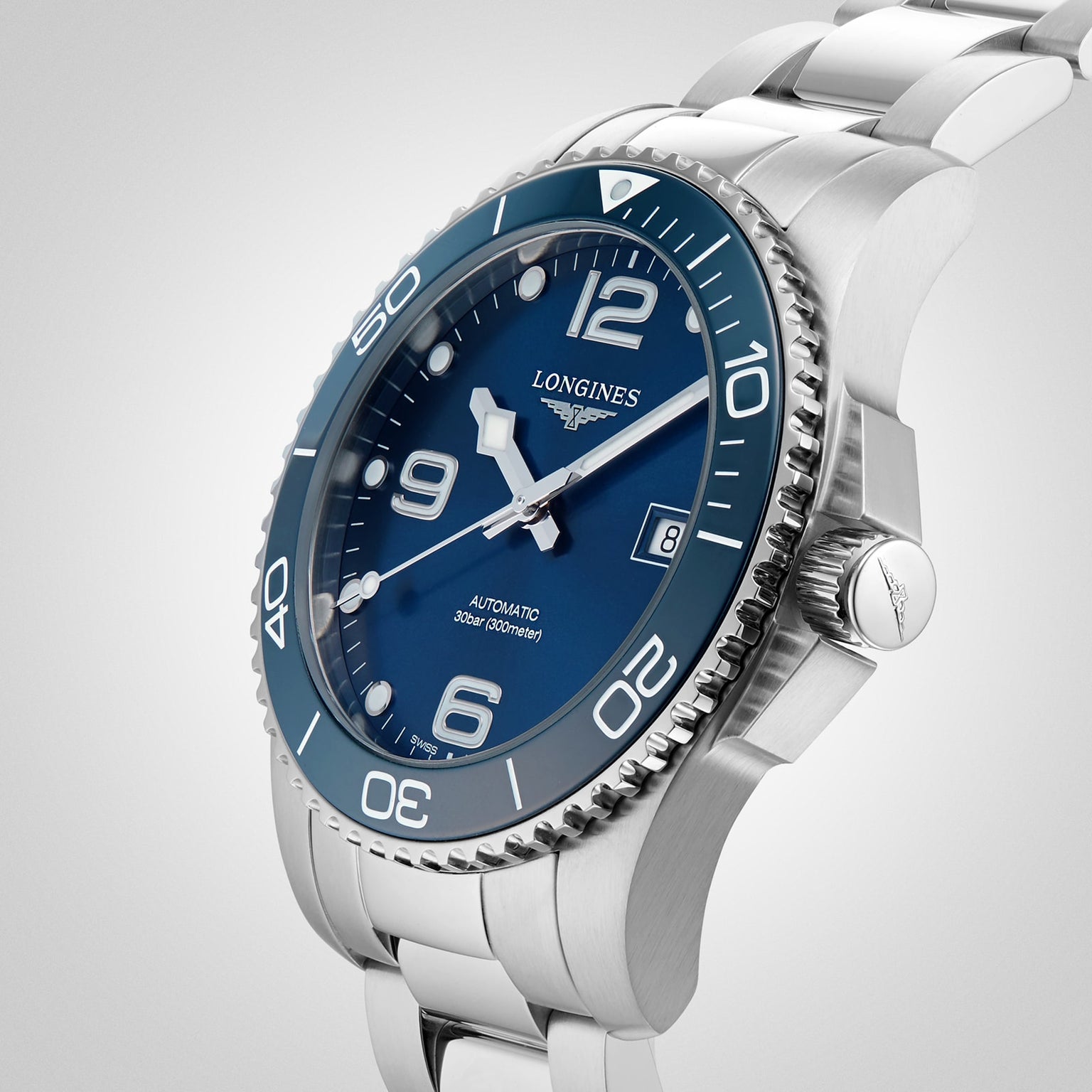 The Longines HydroConquest, a stainless steel diving watch with a blue dial, silver hour markers, and rotating bezel, is displayed against a plain light background. This stylish timepiece is elegant and water resistant.