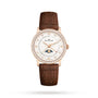 The Blancpain Villeret Quantième Phases de Lune is a luxury watch with a brown leather strap, round 18K red gold diamond-set case, Roman numerals, date display, and an elegant moon phase on the dial.