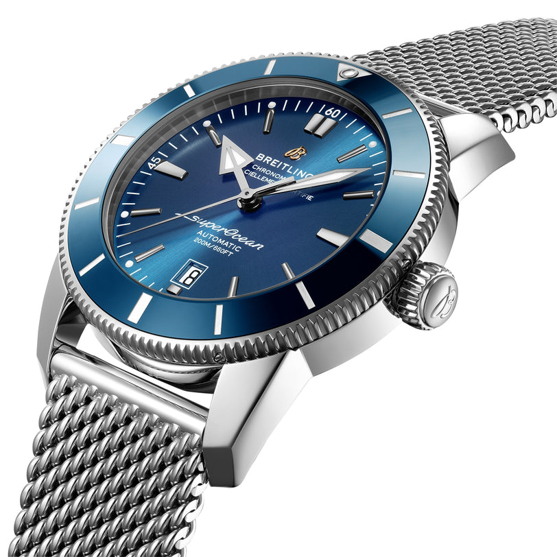 A close-up of the Breitling Superocean Heritage B20 Automatic 46, featuring a blue dial with silver indices, date display, stainless steel mesh bracelet, Breitling B20 calibre movement, and water resistance.