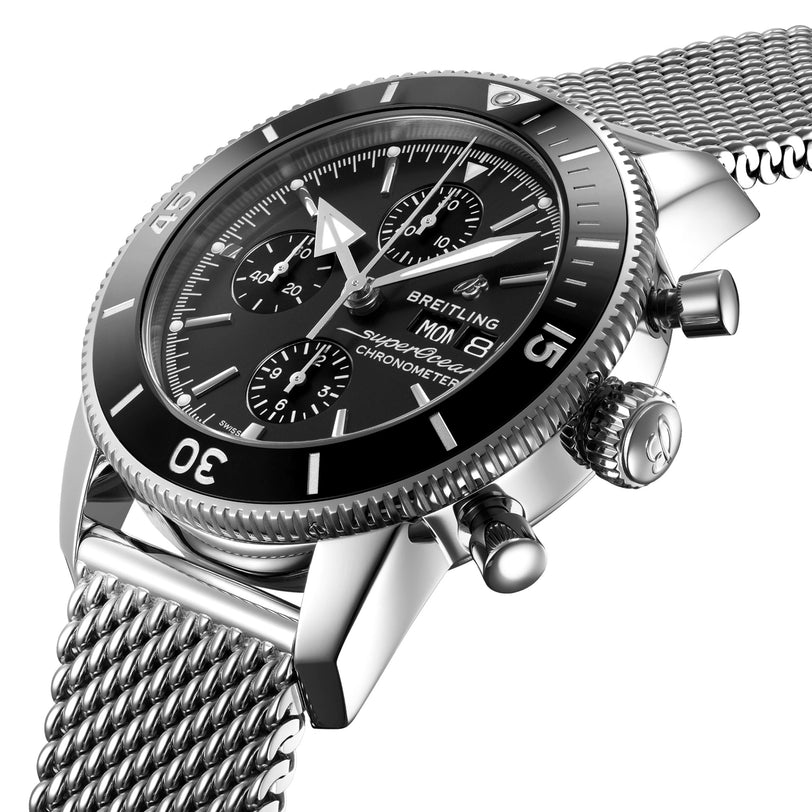 Close-up of the Breitling Superocean Heritage Chronograph 44, showcasing its stainless steel case, black dial with three subdials, date display, and a matching stainless steel mesh strap.