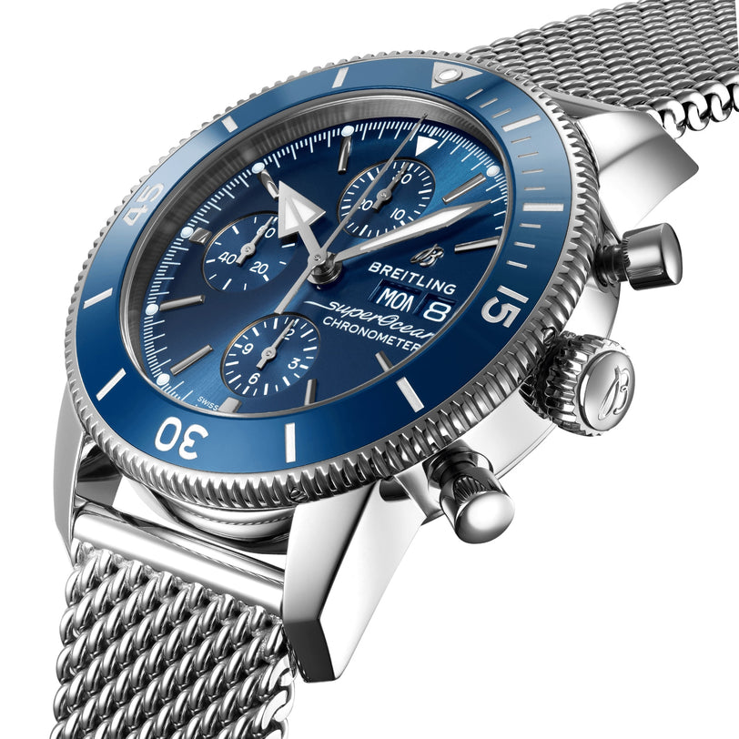 A close-up of a Breitling Superocean Heritage Chronograph 44 with a blue dial, stainless steel mesh bracelet, and three subdials powered by the Breitling 13 calibre.