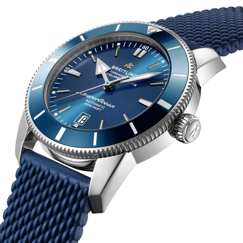 Close-up of a Breitling Superocean Heritage B20 Automatic 46 wristwatch featuring a blue dial, silver hour markers, luminescent hands, a blue textured strap, water resistance, and a date window at 6 o’clock.
