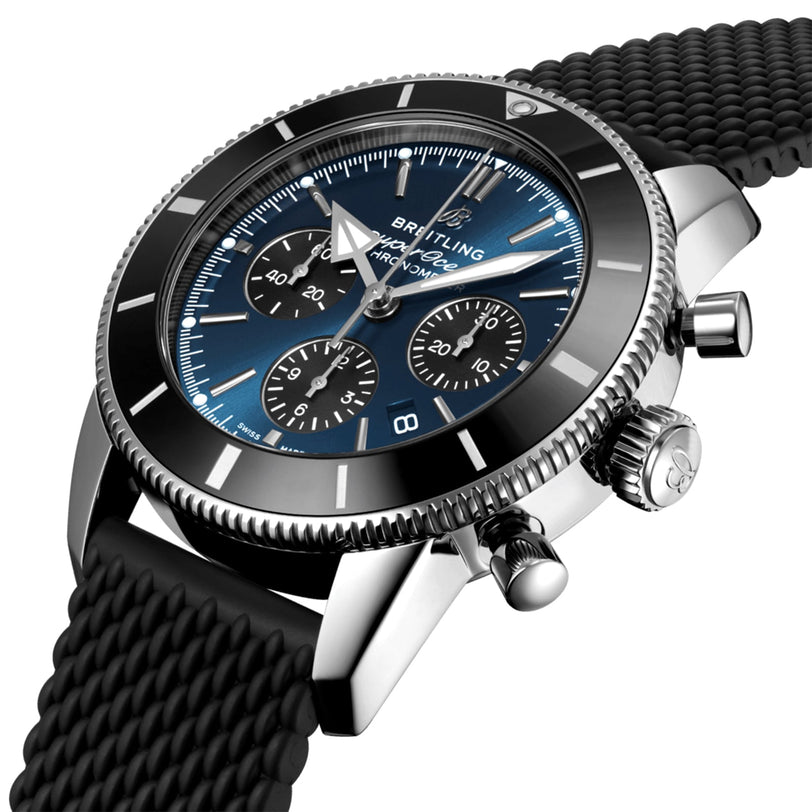 Close-up of the Breitling Superocean Heritage B01 Chronograph 44, featuring a blue dial, black bezel, black mesh strap, and water resistance, powered by the precise Breitling 01 calibre.