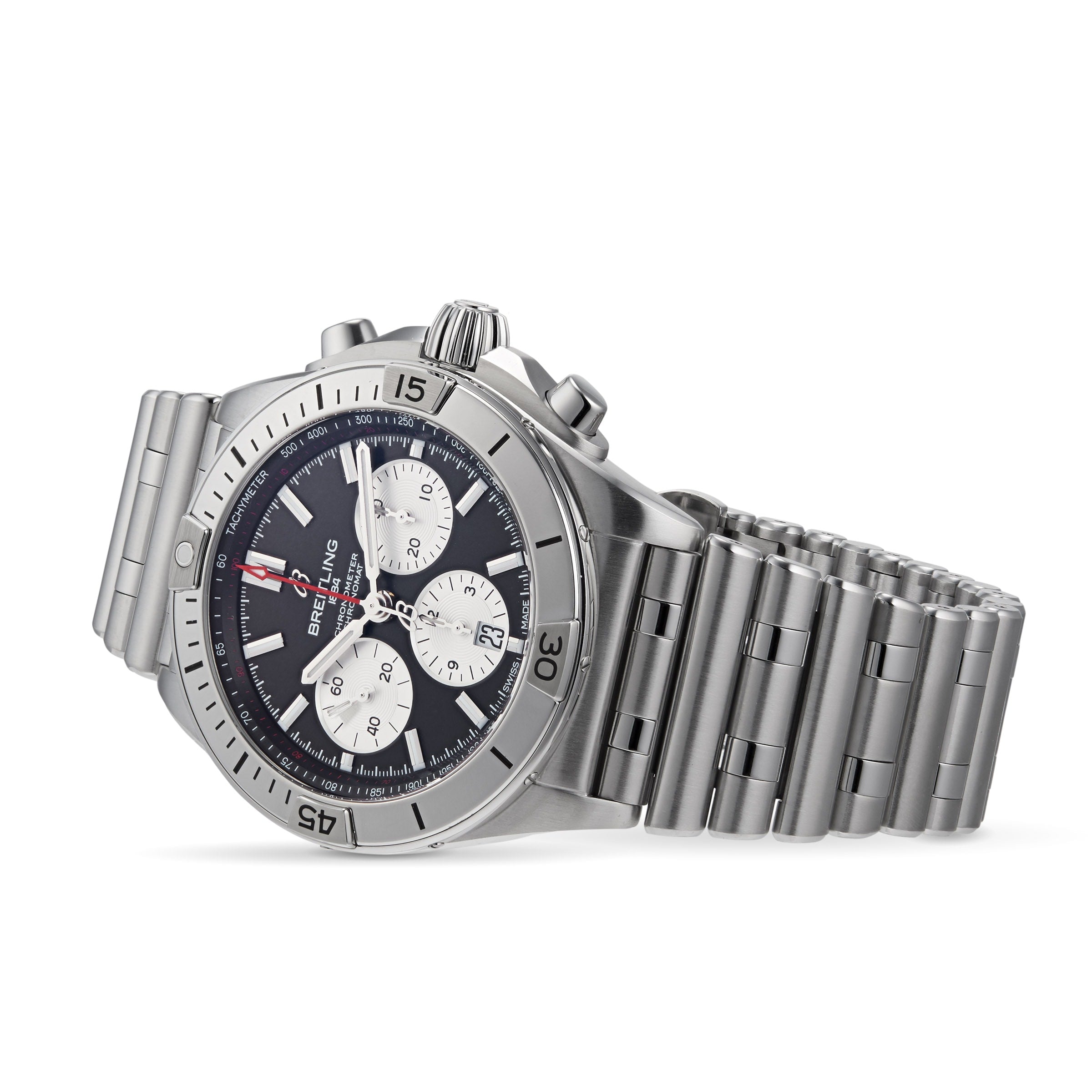 Shown at an angle is a Breitling Chronomat B01 42 watch featuring a stainless steel case, black dial with three subdials, and a metal link bracelet.