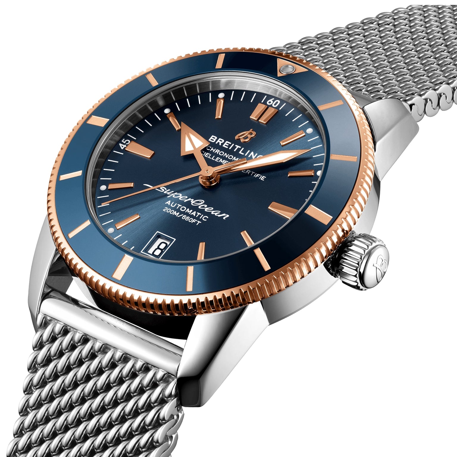 A close-up of the Breitling Superocean Heritage B20 Automatic 42 featuring a blue dial, rose gold accents, luminescent hands, and a silver mesh strap.