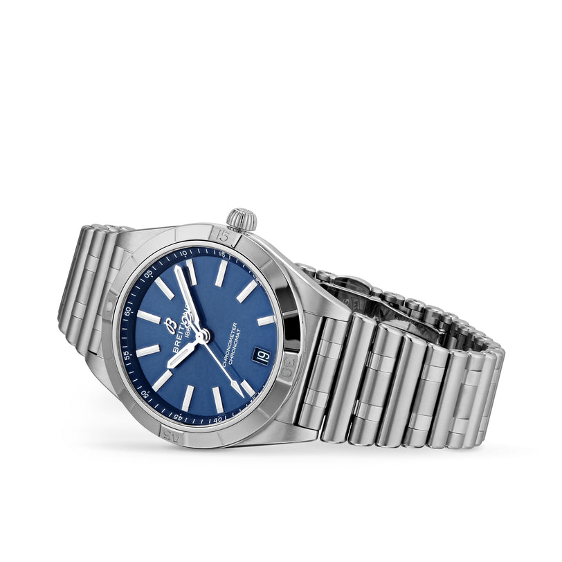 The Breitling Chronomat Automatic 36 is a stainless steel wristwatch with a blue dial, silver hour markers, COSC-certified Breitling 10 calibre, date at 3 oclock, and a metal link bracelet.