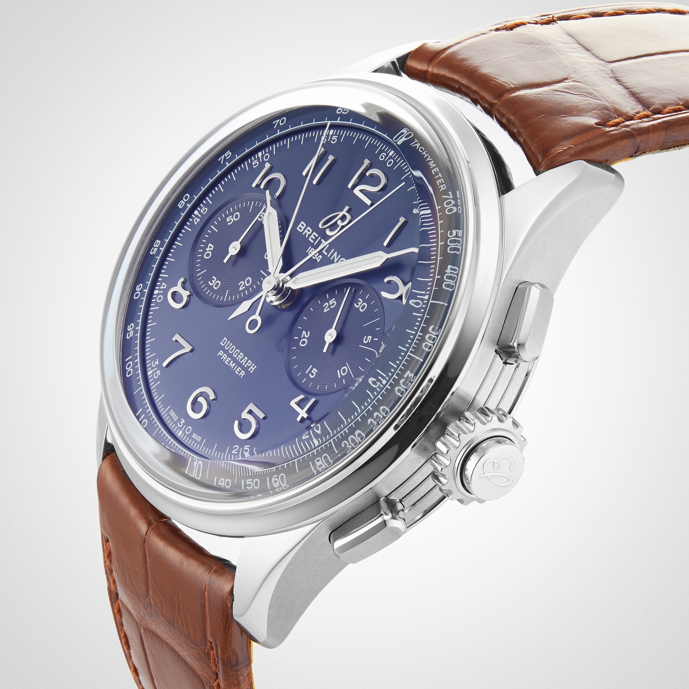 The Breitling Premier B15 Duograph 42 is a luxury watch featuring a blue dial, chronograph subdials, and a brown leather strap.