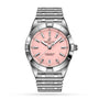 The Breitling Chronomat 32 is a stainless steel wristwatch with a pink dial, silver hour markers and hands, a date window at 6 o’clock, and a signature Rouleaux bracelet.