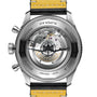 Close-up of the Breitling Super AVI B04 Chronograph GMT 46 Tribute To Vought F4U, highlighting its transparent caseback with visible mechanical movement, engraved details, and yellow leather strap—celebrating the F4U Corsair’s legacy.