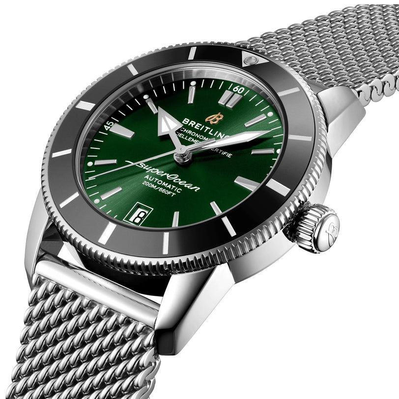 Close-up of the Breitling Superocean Heritage B20 Automatic 42 with a green dial, stainless steel case, and silver mesh bracelet.
