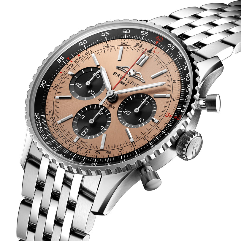Close-up of the Breitling Navitimer B01 Chronograph 43 with a beige dial, black subdials, stainless steel bracelet, ridged bezel, and precision-engineered Breitling 01 calibre.