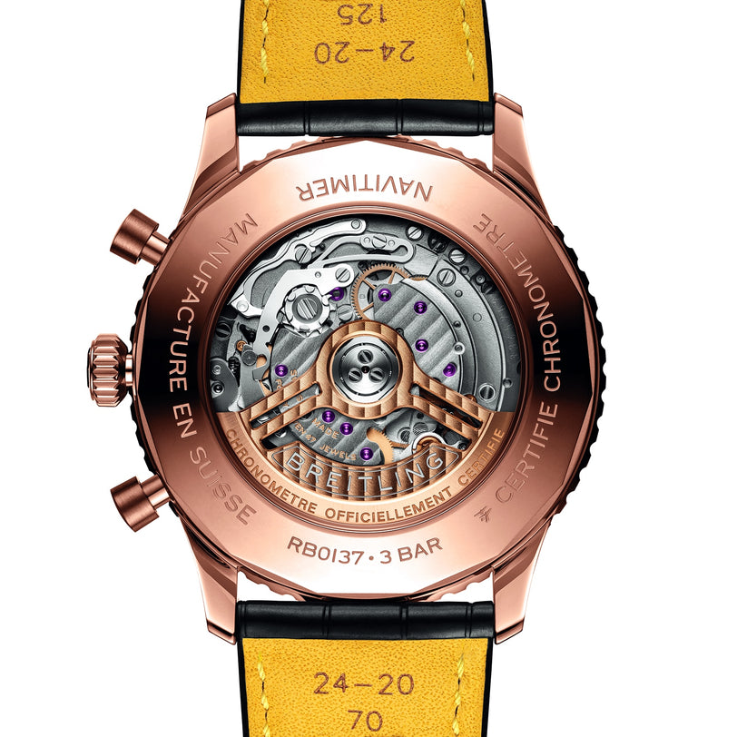 Close-up of the back of a Breitling Navitimer B01 Chronograph 46, showcasing its exposed Breitling 01 calibre movement, engraved details, and distinctive yellow leather strap.