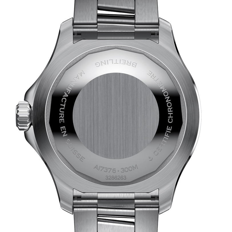 Close-up of the Breitling Superocean Automatic 44s stainless steel case back, showing engraved markings, serial number, and metal bracelet.