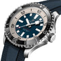 Close-up of a Breitling Superocean Automatic 44 watch with a blue dial, white and silver markers, rotating bezel, textured blue strap, and water-resistant automatic movement.