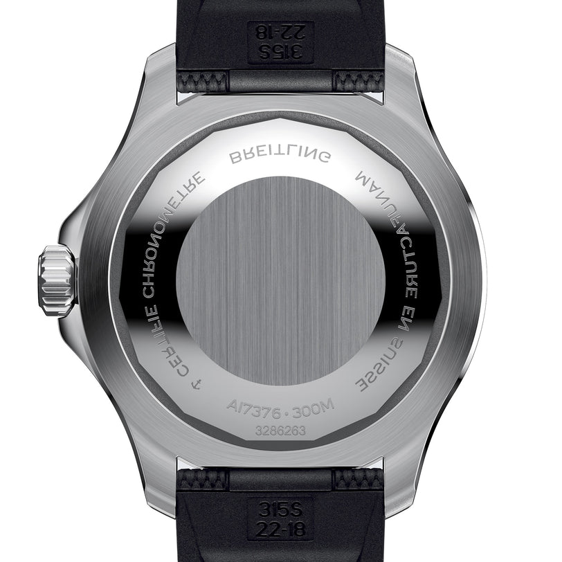 Close-up of the Breitling Superocean Automatic 44 dive watchs back, featuring engravings on its brushed stainless steel case and a black strap with prominent markings.