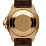 Close-up of the back of a gold Breitling Superocean Automatic 44 with engraved text, brown leather strap, and visible model and serial numbers, known for its water-resistant design.