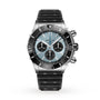 A Breitling Super Chronomat B01 44 in silver featuring a light blue dial, black subdials and bezel, plus a textured black Rouleaux strap, displayed on a white background.