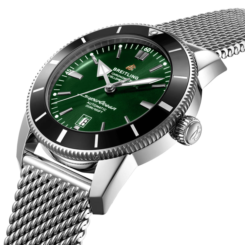 A close-up of the Breitling Superocean Heritage B20 Automatic 46 wristwatch featuring a green dial, date display, B20 movement, 46mm stainless steel case, and mesh bracelet.